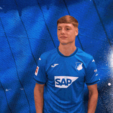 a man wearing a blue shirt that says sap