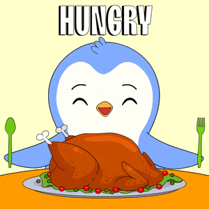 a cartoon penguin is sitting at a table eating a turkey with the word hungry above it