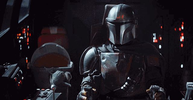 a man in a helmet sitting in a dark room