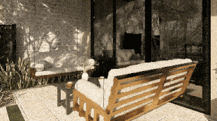 a couch with a white cushion sits on a patio in front of a window