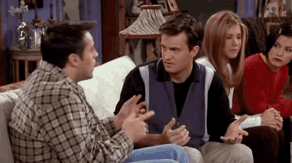 a group of people are sitting on a couch talking .