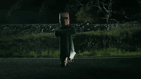 a person is flying over a road at night .