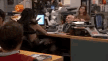 a blurry picture of a group of people sitting at a desk