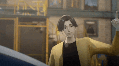 a man in a yellow jacket and black shirt is standing in a room .