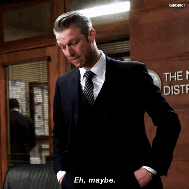 a man in a suit and tie is standing in front of a sign that says " the new district "