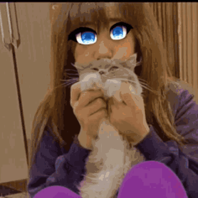 a girl with blue eyes is holding a cat in her arms
