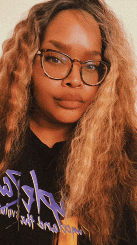 a woman wearing glasses and a t-shirt that says ssh on it