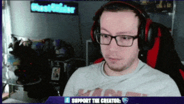 a man wearing glasses and headphones is sitting in front of a sign that says " ghostrider "