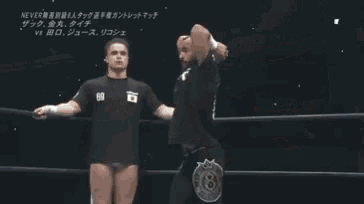 a wrestling match is being shown on a television screen