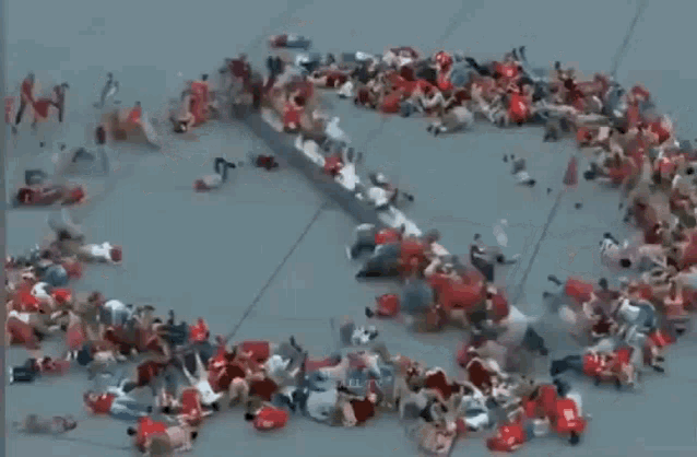 a bunch of people are laying on the ground in a circle with the letter s on it