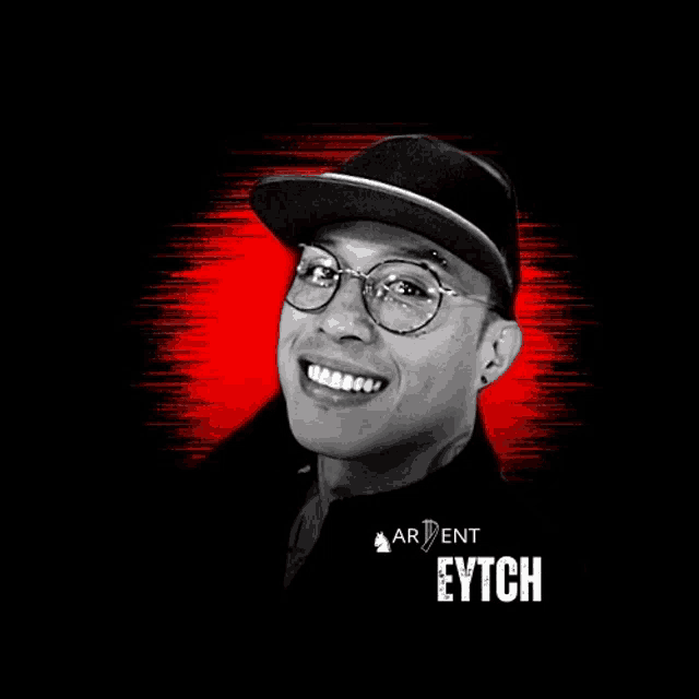 a man wearing glasses and a hat with the name eytch