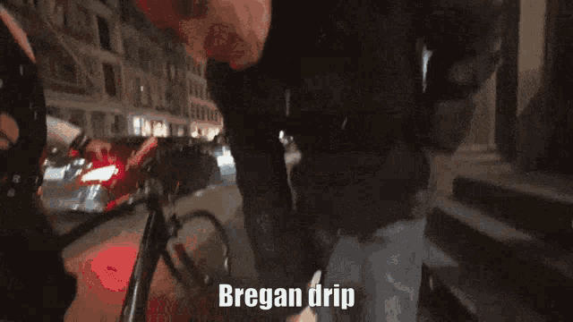 a person is holding a helmet with the words bregan drip on it .