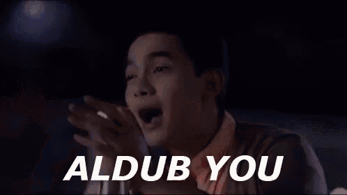 a man is making a funny face and saying `` aldub you '' with his hands .