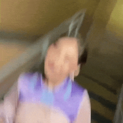 a blurry picture of a woman standing on a set of stairs wearing bunny ears .