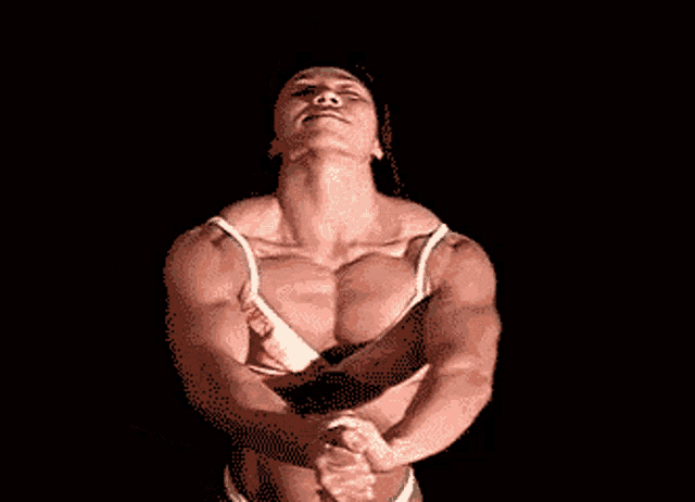 a pixelated image of a woman flexing her muscles in a bra