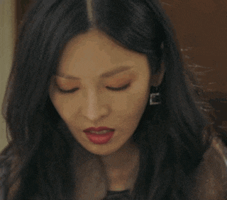 a close up of a woman 's face with earrings on her ear