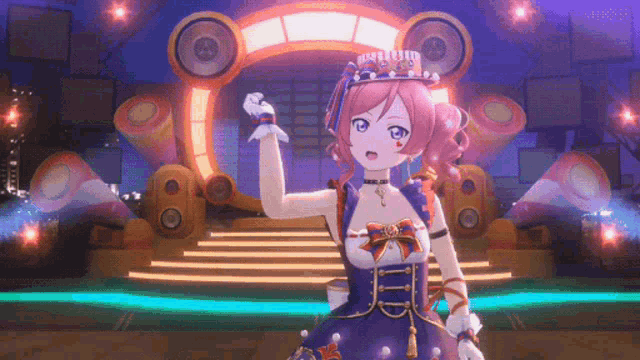 a girl with a crown on her head is standing in front of a stage