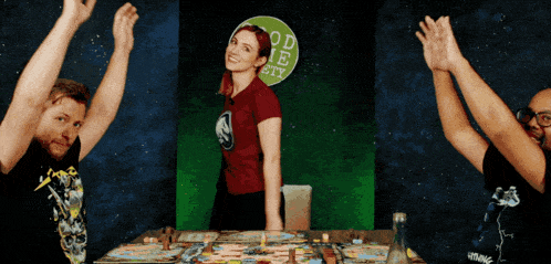 a woman in a red shirt is standing in front of a green sign that says good society