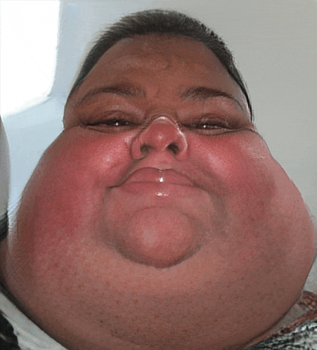 a close up of a person 's face with a large neck