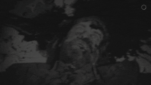 a black and white photo of a person with their mouth open in the water