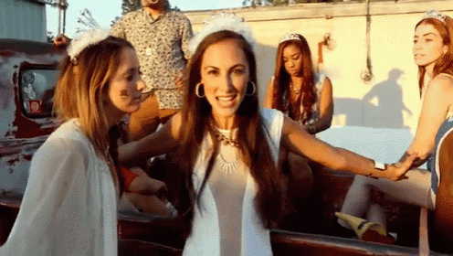 a group of women are posing for a picture in a truck