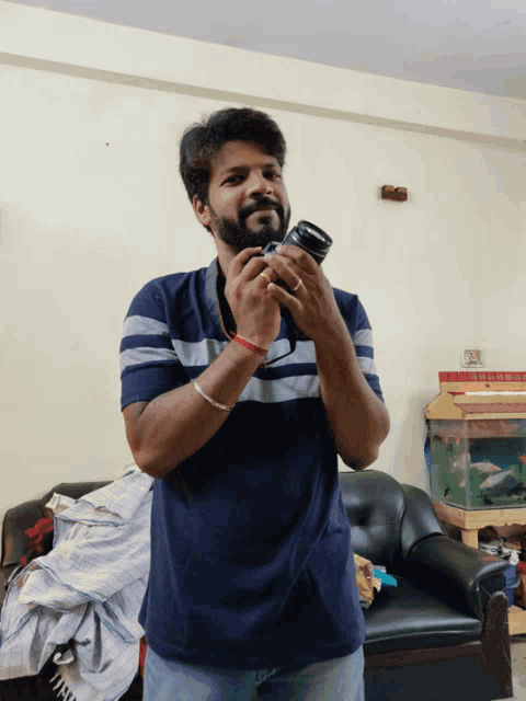 a man is holding a camera in his hands and smiling