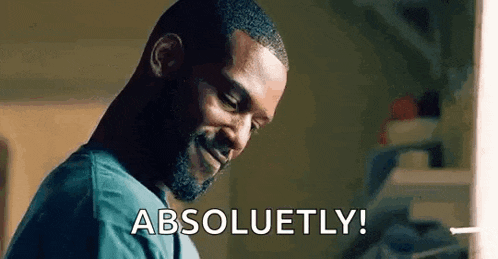 a man with a beard is smiling and says `` absolutely ! ''