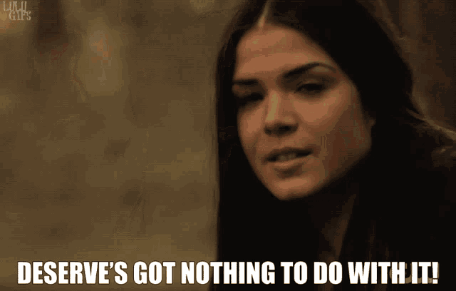 a gif of a woman says deserve 's got nothing to do with it