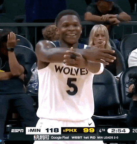 a basketball player with the number 5 on his jersey is smiling
