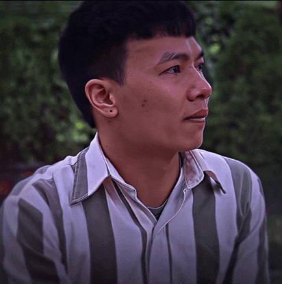 a man wearing a striped shirt with a white collar