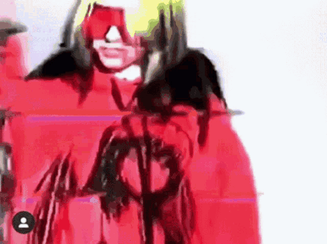 a blurry picture of a person wearing a red jacket .