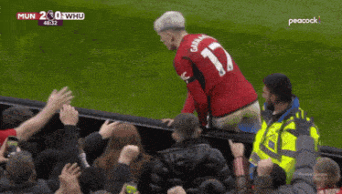 a man wearing a red jersey with the number 17 on the back