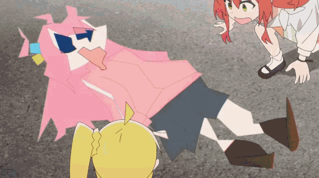 a girl in a pink shirt is laying on the ground while another girl looks on
