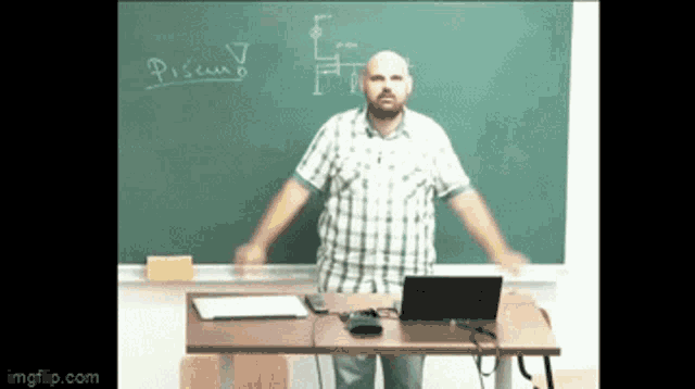 a man is standing in front of a blackboard with the word pisemb written on it