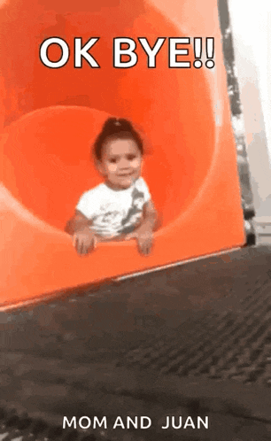 a little girl is sliding down an orange slide with the words ok bye mom and juan below her .
