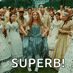 a woman in a blue dress is standing in front of a crowd of people with the caption superb