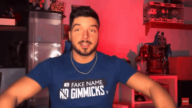 a man is wearing a fake name no gimmicks t-shirt