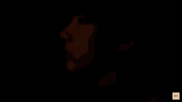 a man is holding a light in front of a sign that says tryum antizever