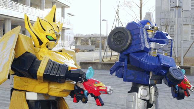 two robots are standing next to each other and one has a wheel on it