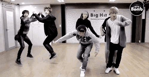 a group of young men are dancing in a dance studio .