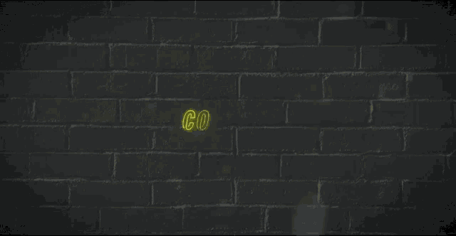 a neon sign says come on on a brick wall