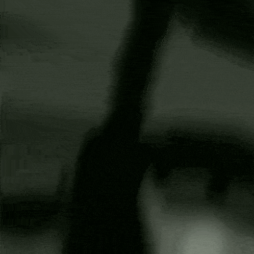 a blurry black and white photo of a man standing in a room .