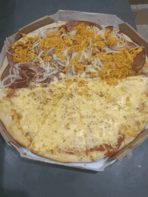 a pizza in a cardboard box has a slice missing