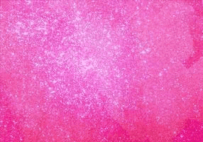 a woman in a denim jacket stands in front of a pink background with a black star