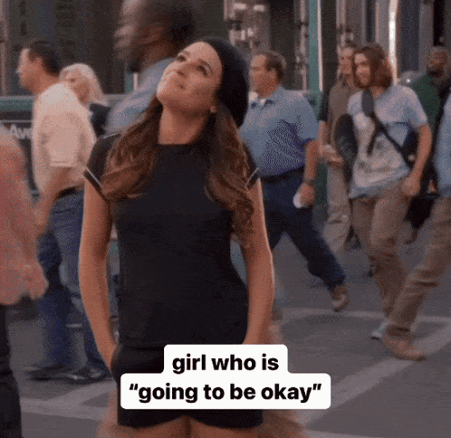 a woman in a black dress is standing on a street with a caption that says " girl who is going to be okay "