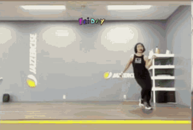 a woman is dancing in front of a wall that says friday on it