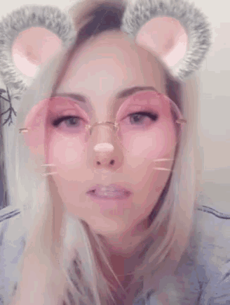 a woman wearing pink glasses with mouse ears