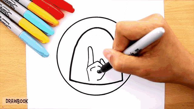 a person is drawing a circle with sharpie markers on the table