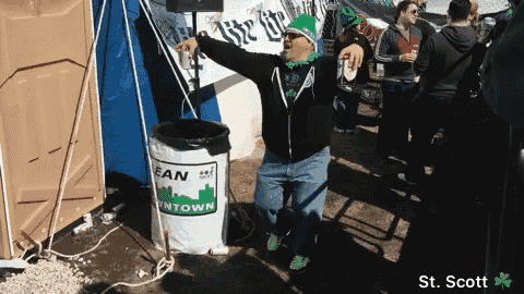 a man standing in front of a trash can that says lean on town