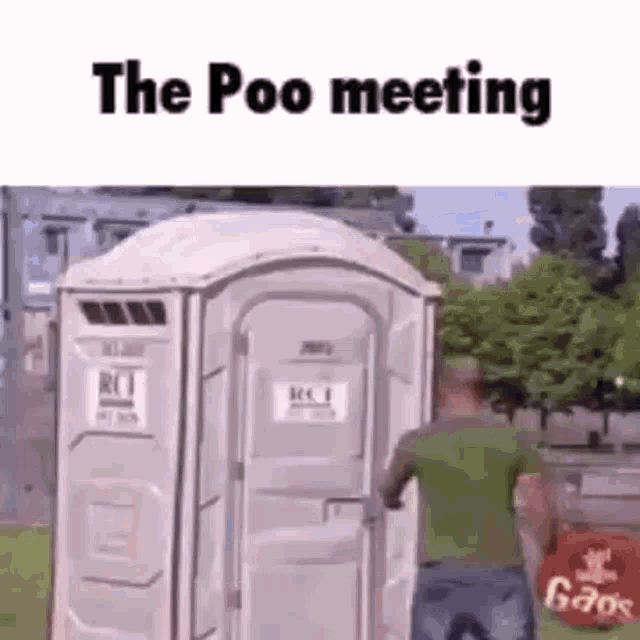 a man is standing next to a portable toilet in a park .